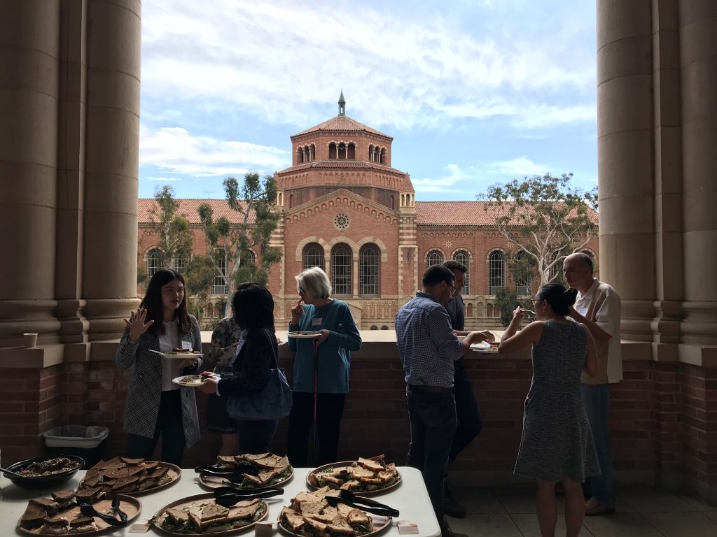 Members of the Working Group in Memory Studies enjoying a lunch on the loggia inside Royce Hall. 